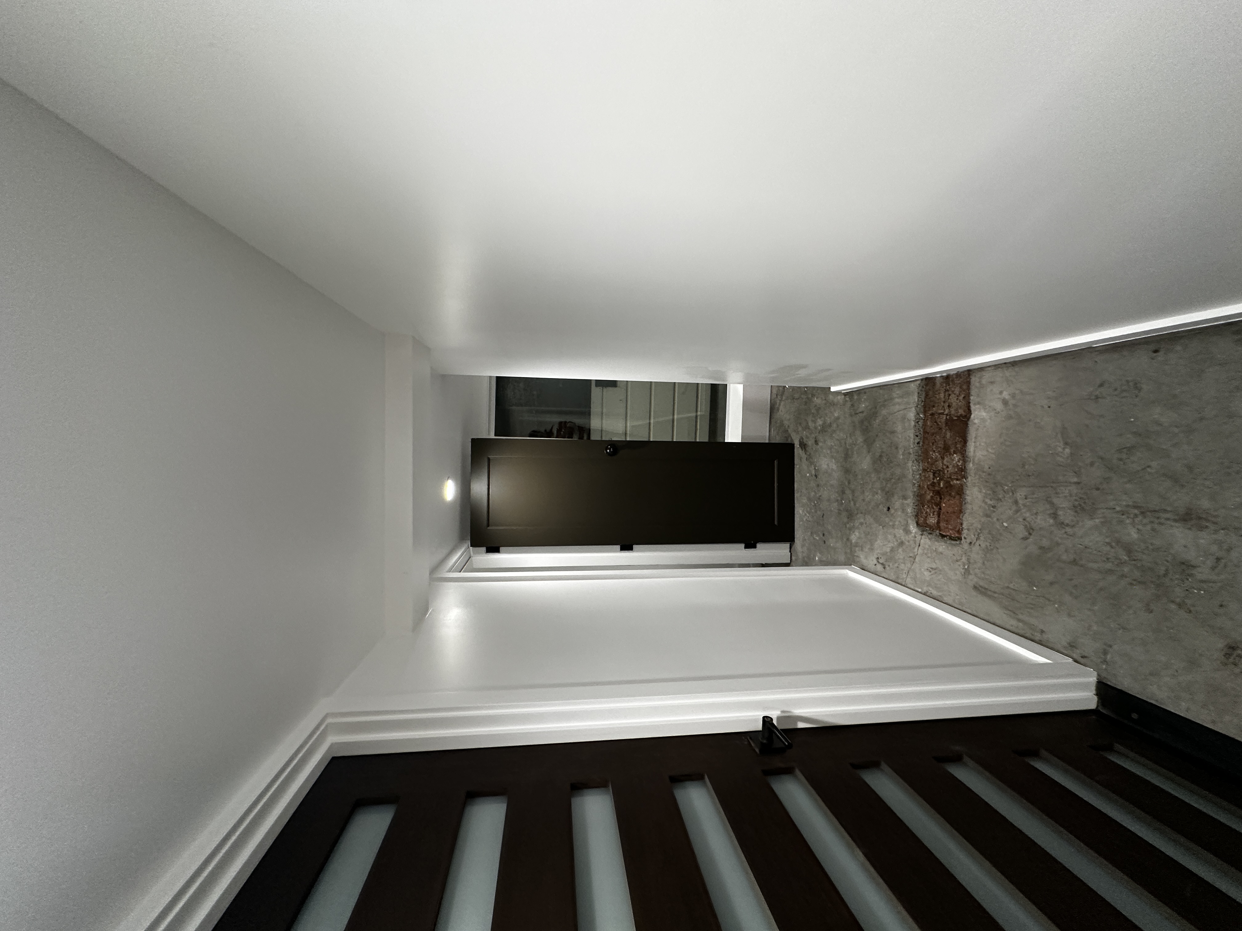 Freshly painted white hallway with dark doors